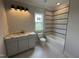 A bright bathroom features elegant vanity with modern fixtures and tiled shower and tub at 4905 Hidden Pasture Way, Zebulon, NC 27597