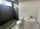 Well-lit bathroom featuring new vanity, marble countertop, and tile surround shower at 4905 Hidden Pasture Way, Zebulon, NC 27597
