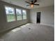 An airy bedroom boasts abundant natural light from three large windows overlooking a green field at 4905 Hidden Pasture Way, Zebulon, NC 27597