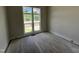 Bright bedroom featuring hardwood floors, large windows with natural light, and picturesque outdoor views at 4905 Hidden Pasture Way, Zebulon, NC 27597