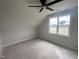 Attic bedroom with ceiling fan, large window, and natural light at 4905 Hidden Pasture Way, Zebulon, NC 27597