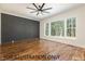 Bright bedroom with large windows and a decorative accent wall at 4905 Hidden Pasture Way, Zebulon, NC 27597