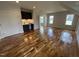Bonus room featuring wood floors, wet bar with sink and custom cabinets, and plenty of light at 4905 Hidden Pasture Way, Zebulon, NC 27597