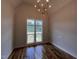 Dining area with hardwood floors and natural light coming through the large windows at 4905 Hidden Pasture Way, Zebulon, NC 27597