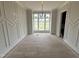 Bright dining room with large windows, decorative molding, and light hardwood floors, perfect for entertaining guests at 4905 Hidden Pasture Way, Zebulon, NC 27597