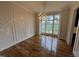 Elegant dining room with decorative molding, modern light fixture, and large windows showing exterior views at 4905 Hidden Pasture Way, Zebulon, NC 27597