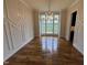 Elegant dining room with decorative molding, modern light fixture, and large windows showing exterior views at 4905 Hidden Pasture Way, Zebulon, NC 27597