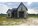 Charming two-story home with gray siding and dark accents, nestled on a spacious lot, ready for landscaping at 4905 Hidden Pasture Way, Zebulon, NC 27597