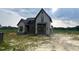 Stylish two-story home with a modern design, featuring gray siding, black trim, and a welcoming entrance at 4905 Hidden Pasture Way, Zebulon, NC 27597