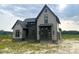 Beautiful two-story home with stone accents and gray siding, offering modern curb appeal and a welcoming facade at 4905 Hidden Pasture Way, Zebulon, NC 27597