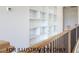 Hallway features built-in bookshelves and wood railing at 4905 Hidden Pasture Way, Zebulon, NC 27597