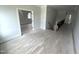 Upstairs hallway featuring hardwood floors, staircase, and views into other rooms at 4905 Hidden Pasture Way, Zebulon, NC 27597