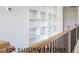 Hallway featuring a wood railing and shelves at 4905 Hidden Pasture Way, Zebulon, NC 27597