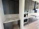 Modern kitchen features dark cabinets, stainless steel appliances, and a spacious layout perfect for cooking at 4905 Hidden Pasture Way, Zebulon, NC 27597