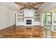 Cozy living room with a fireplace, built-ins, and wood beams at 4905 Hidden Pasture Way, Zebulon, NC 27597