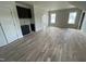 Spacious living room with gleaming hardwood floors, black cabinets, and plenty of natural light at 4905 Hidden Pasture Way, Zebulon, NC 27597
