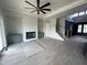 Spacious living room with a fireplace, built-in cabinets, modern ceiling fan, and an open floor plan at 4905 Hidden Pasture Way, Zebulon, NC 27597