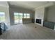 Spacious living room with a fireplace, custom cabinets and light hardwood floors at 4905 Hidden Pasture Way, Zebulon, NC 27597