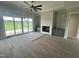 Bright living room with a fireplace, built-in cabinets, hardwood floors, and access to the outdoors through sliding doors at 4905 Hidden Pasture Way, Zebulon, NC 27597