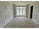 Bright living room with decorative molding, natural light and light hardwood floors at 4905 Hidden Pasture Way, Zebulon, NC 27597