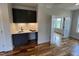 A new home offers a charming living area with a convenient wet bar and hardwood floors at 4905 Hidden Pasture Way, Zebulon, NC 27597