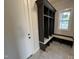 A sleek mudroom with a built-in bench, provides a convenient and organized entry space at 4905 Hidden Pasture Way, Zebulon, NC 27597