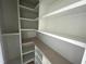 Walk-in pantry with white shelves, maximizing storage and organization at 4905 Hidden Pasture Way, Zebulon, NC 27597
