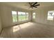 Bright room with large windows offering a view, light hardwood floors, and modern trim, ready for customization at 4905 Hidden Pasture Way, Zebulon, NC 27597