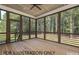 Screened porch with wood floors, ceiling fan, and view of surrounding trees at 4905 Hidden Pasture Way, Zebulon, NC 27597