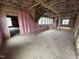 An unfinished room has insulation installed in the walls, and the floor is already complete in this build at 4905 Hidden Pasture Way, Zebulon, NC 27597