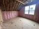 An attic room is being constructed with insulation and the floor already installed and with windows facing the outside at 4905 Hidden Pasture Way, Zebulon, NC 27597