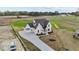Aerial shot of a home with a long driveway, well-maintained lawn, and exterior architectural details at 4909 Hidden Pasture Way, Zebulon, NC 27597