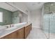 Elegant bathroom boasting double vanity, large mirror, and glass-enclosed shower with rainfall showerhead at 4909 Hidden Pasture Way, Zebulon, NC 27597