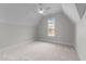 Bright bedroom featuring plush carpeting, ceiling fan, and a large window overlooking the landscape at 4909 Hidden Pasture Way, Zebulon, NC 27597