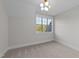 Bright bedroom with neutral carpeting, a modern light fixture, and a large window with a view at 4909 Hidden Pasture Way, Zebulon, NC 27597
