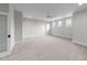 Spacious bedroom with neutral carpeting, a ceiling fan, and large windows providing natural light at 4909 Hidden Pasture Way, Zebulon, NC 27597