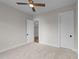 Bright bedroom featuring plush carpeting, ceiling fan, and doorway at 4909 Hidden Pasture Way, Zebulon, NC 27597