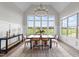 A bright dining room features large windows with views of the green outdoors at 4909 Hidden Pasture Way, Zebulon, NC 27597