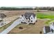 Stunning white modern farmhouse with a long drive on a large lot with green spaces at 4909 Hidden Pasture Way, Zebulon, NC 27597