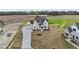 Stunning white modern farmhouse with a long drive on a large lot with green spaces at 4909 Hidden Pasture Way, Zebulon, NC 27597