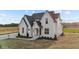 A gorgeous home complete with a manicured lawn, a covered front porch, and lush landscaping at 4909 Hidden Pasture Way, Zebulon, NC 27597