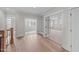 Bright hallway featuring hardwood floors, built-in shelving, and doorways leading to other rooms at 4909 Hidden Pasture Way, Zebulon, NC 27597