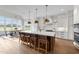 A stunning kitchen with a spacious island, stylish pendant lighting, and an adjacent dining area at 4909 Hidden Pasture Way, Zebulon, NC 27597