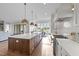 This open kitchen features a large island with seating and modern stainless steel appliances at 4909 Hidden Pasture Way, Zebulon, NC 27597