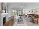 A comfortable living room featuring a fireplace, cozy seating, and lots of natural light at 4909 Hidden Pasture Way, Zebulon, NC 27597
