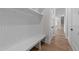 Bright mudroom featuring custom built-ins with a bench and storage space, plus wood floors at 4909 Hidden Pasture Way, Zebulon, NC 27597