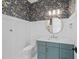 Chic powder room with bold wallpaper, white wainscoting, and stylish fixtures at 4909 Hidden Pasture Way, Zebulon, NC 27597