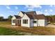 Exterior back view with a screened-in porch, a patio, and newly seeded lawn at 4909 Hidden Pasture Way, Zebulon, NC 27597