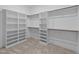Spacious walk-in closet featuring custom shelving and ample storage at 4909 Hidden Pasture Way, Zebulon, NC 27597