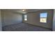 Well-lit bedroom with gray carpeting and two windows at 829 Emmer St, Rolesville, NC 27571